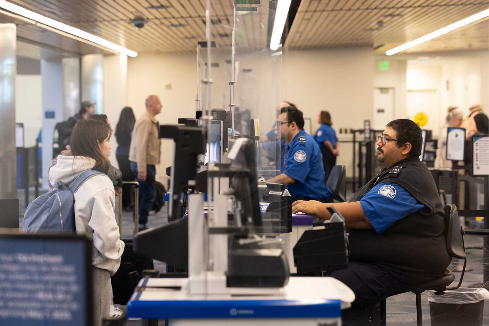 A traveler has their documents checked with the TSA at the San Jose International Airport.