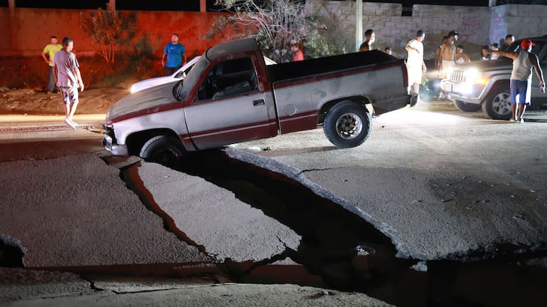 A vehicle is trapped in a fissure caused by an earthquake in La Guaira, Venezuela, Thursday, June 25, 2026.