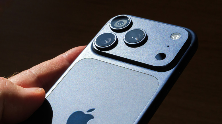 The camera lenses and flashlight on an iPhone 17.