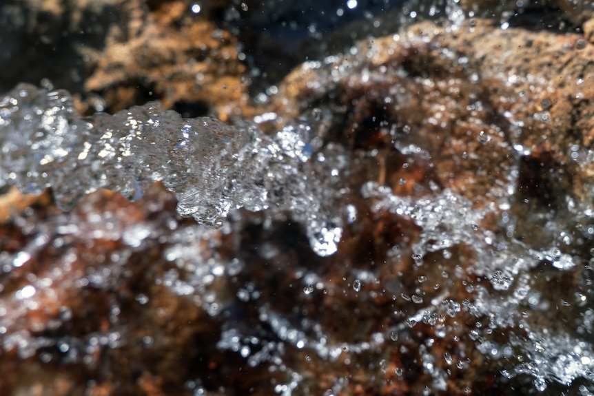 Water flows over rocks.