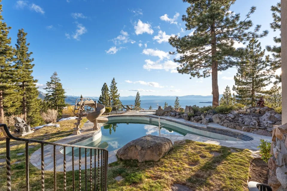 The luxurious estate features a whopping 10 bedrooms, 12 bathrooms, and 3 half-bathrooms across 18,922 square feet on a 2.5-acre lot. Habitat Team