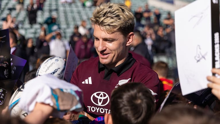 All Blacks first-five Beauden Barrett signs autographs after training at North Harbour Stadium yesterday.