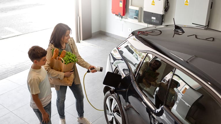 An electric vehicle is charged inside a home.
