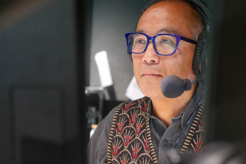 a man wearing a headset looks ahead