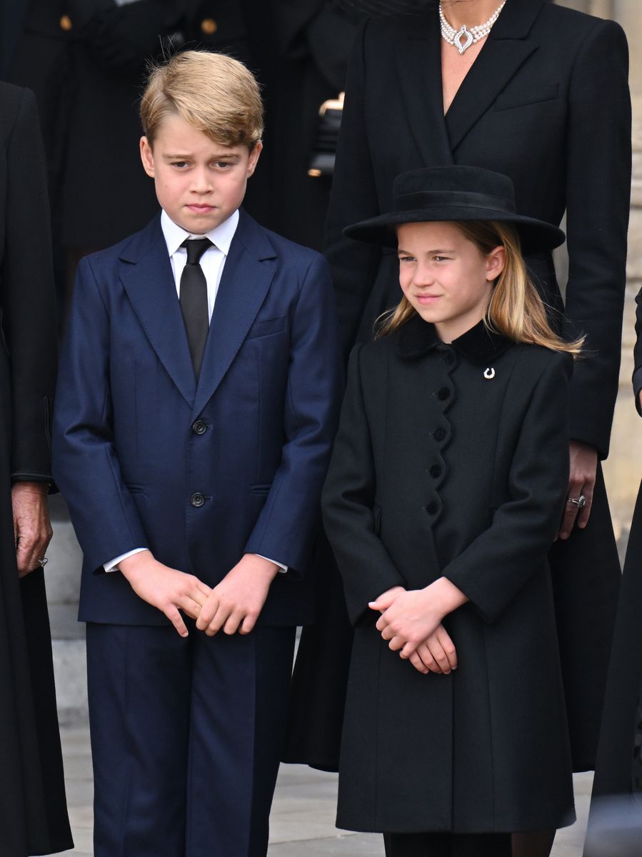 The diamond horseshoe brooch carried special family significance during the solemn occasion.