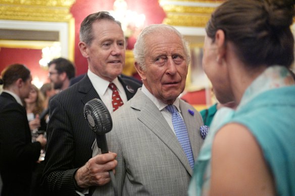Charles gets fan assistance from senior aide Vice-Admiral Sir Tony Johnstone-Burt at the St James’ Palace reception.