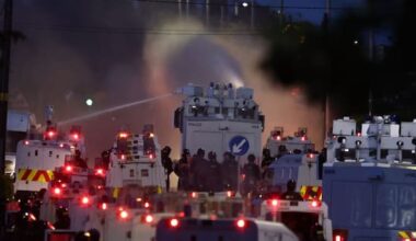 Protesters hit by water cannons after Belfast stabbing attack