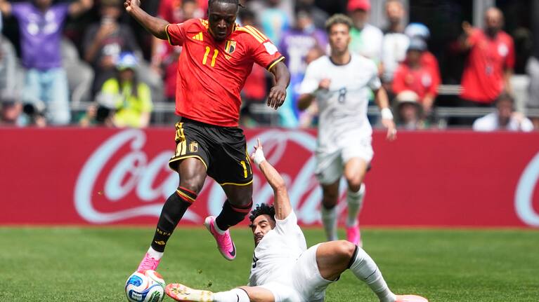 Belgium's Jeremy Doku, top, and Egypt's Marawan Attia battle for the ball during the World Cup Group G match in Seattle.