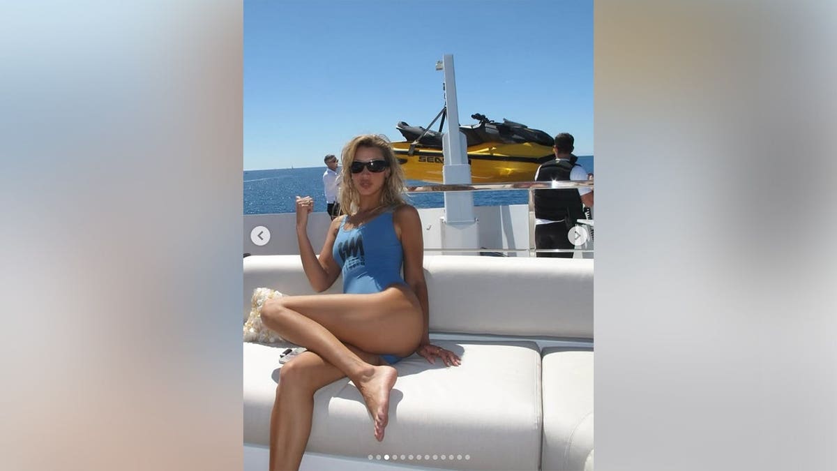Bella Hadid lounging on a sofa on a yacht in 2026.