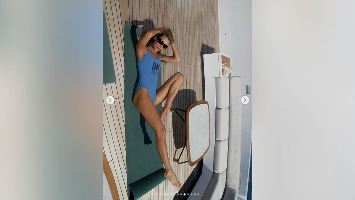 Bella Hadid doing yoga in a blue bikini while on a yacht in 2026.