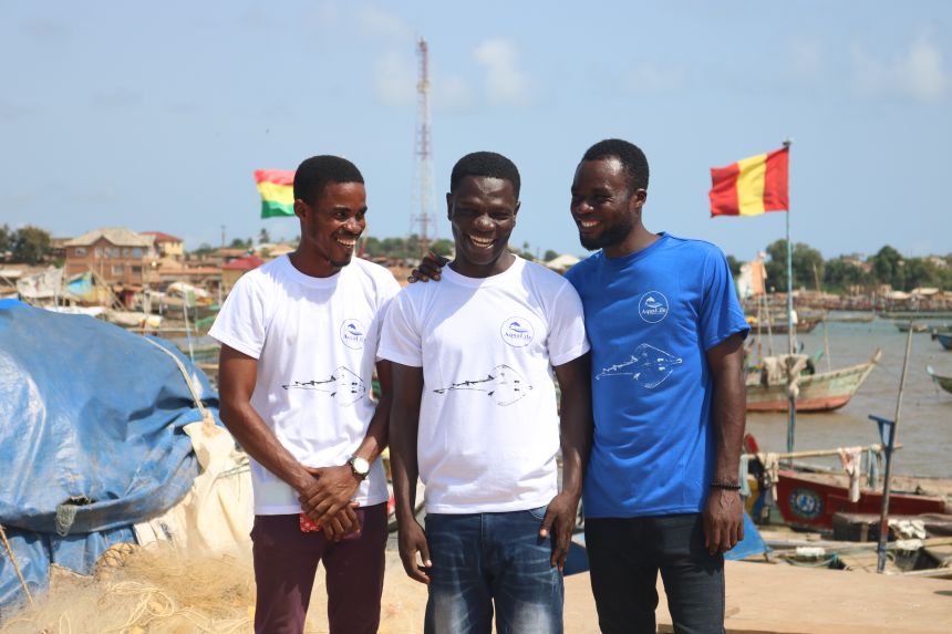 Issah Seidu (center) and AquaLife Conservancy collaborators Isaac Asefuah (left) and Kingsford Amankwah (right), with an image of a guitarfish printed on their shirts.