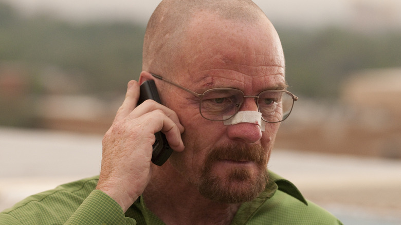 Walter White talking on a cell phone outside