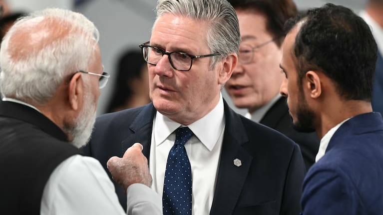 Britain's Prime Minister Keir Starmer, centre, speaks with India's Prime Minister Narendra Modi, ahead of a working session at the G7 summit.