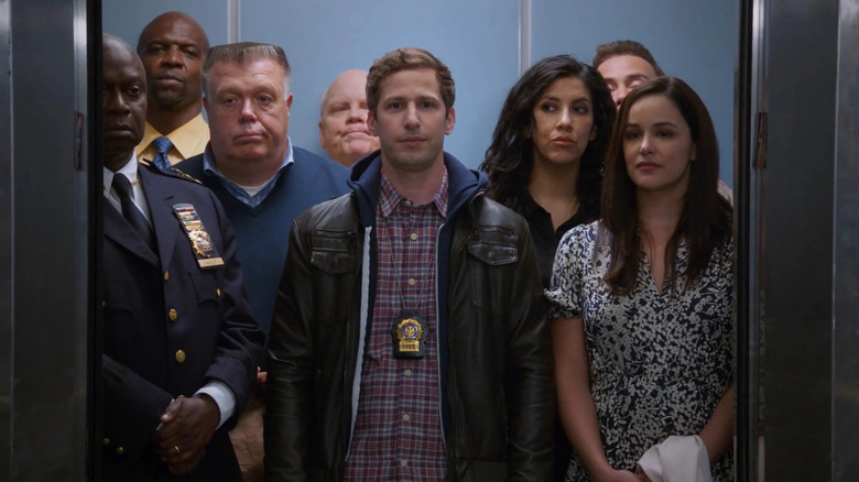 Holt, Terry, Scully, Hitchcock, Jake, Rosa, Boyle, and Amy in an elevator together