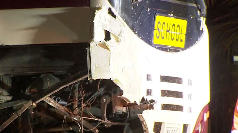 Crashed bus with school sign.