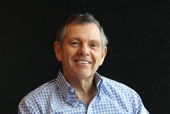 A portrait of a man smiling.