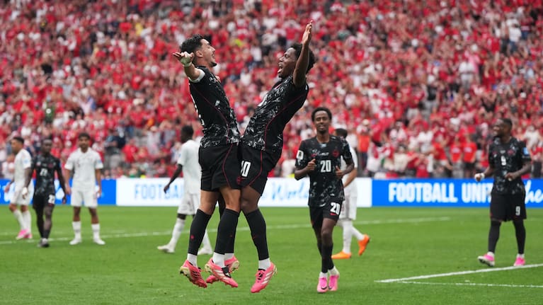 Canada's Jonathan David, front right, celebrates with Stephen Eustaquio,left, after scoring a goal during World Cup Group B match between Canada and Qatar in Vancouver, British Columbia.