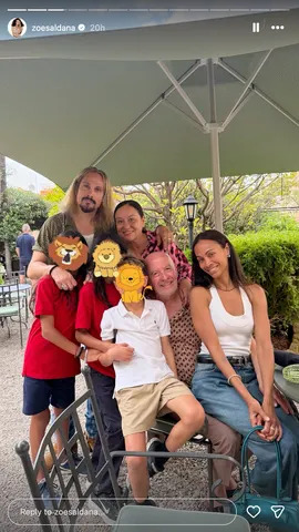 Zoe Saldaña smiles as she sits beside six other people in a photo shared ahead of her 48th birthday on June 18, 2026.Credit: Zoe Saldaña/Instagram