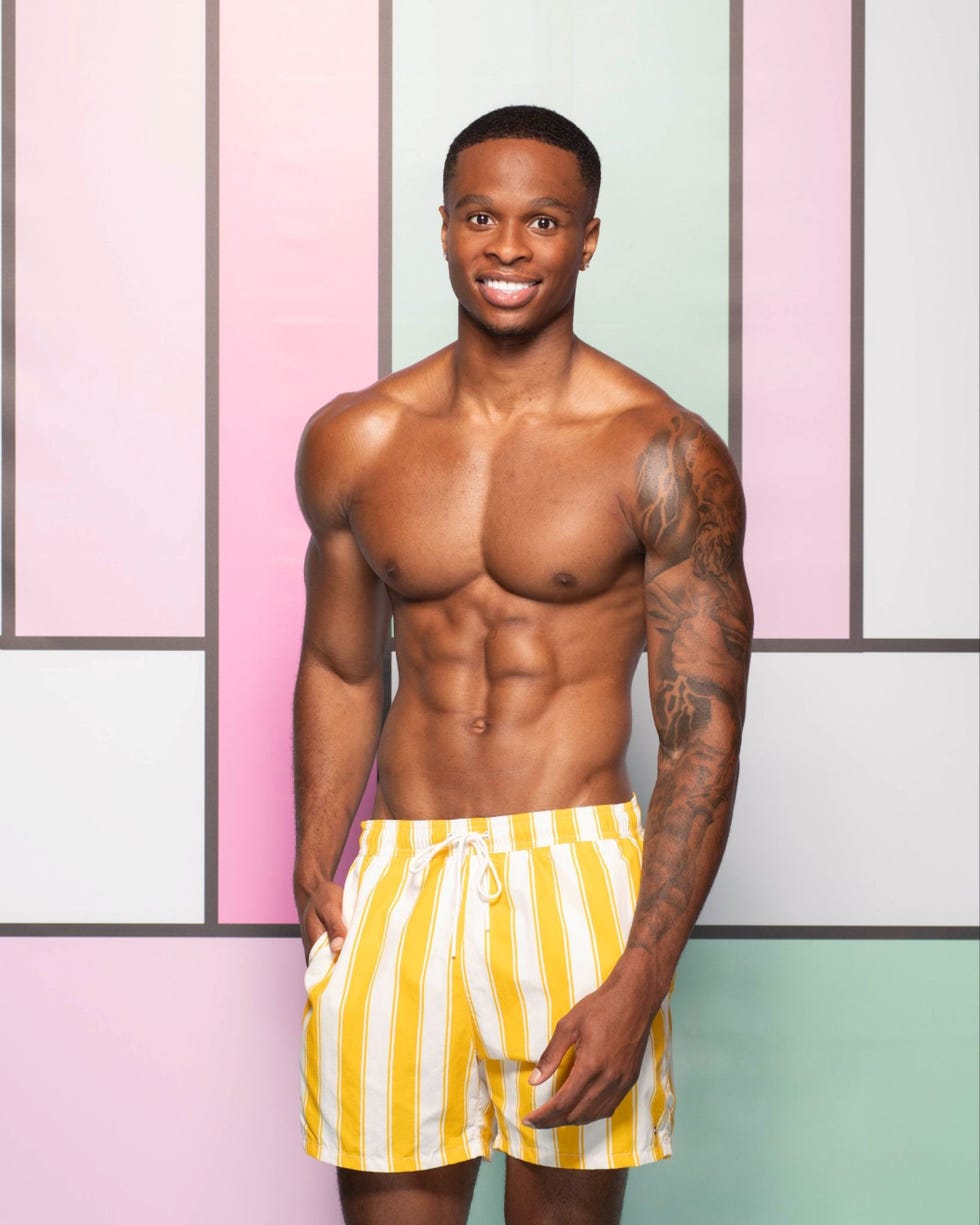 love island 2026 chidi a muscular man wearing yellow striped swim shorts standing against a colorful geometric background