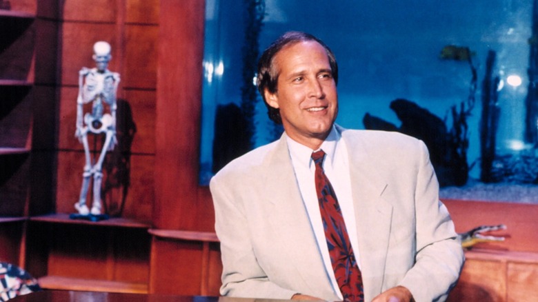Chevy Chase leaning back in his chair on The Chevy Chase Show (1993)