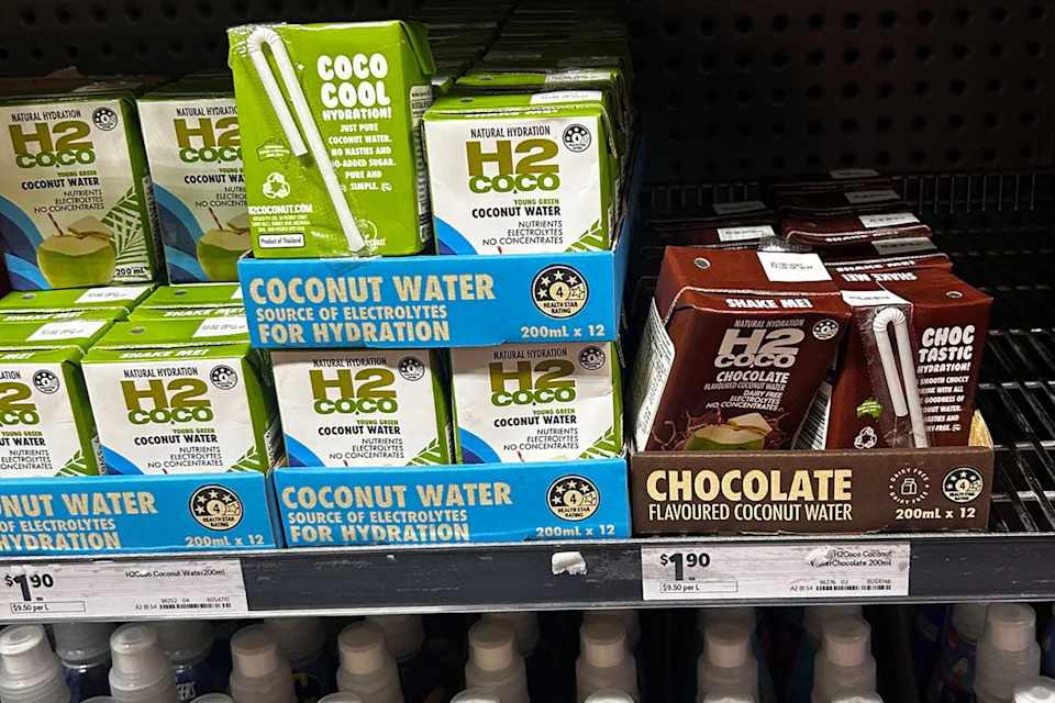 The H2coco 200ml range sits on a shelf in Woolworths. Pictured at the young green coconut flavour, and the chocolate flavour.