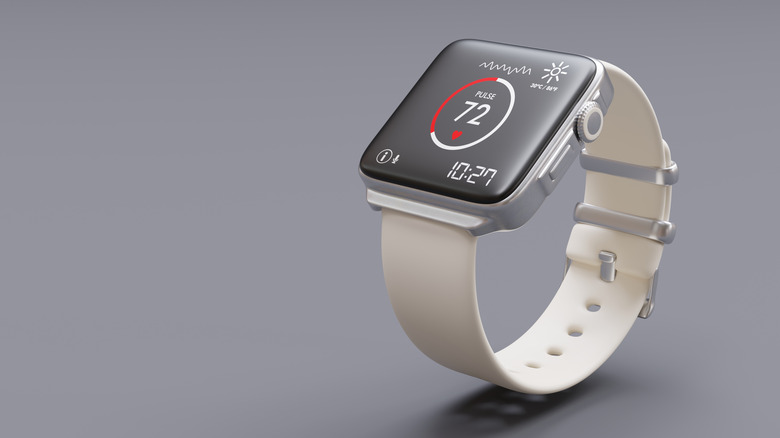 A white banded smartwatch showing a pulse rate on screen.