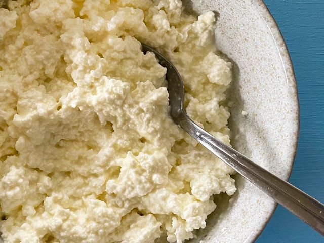 Creamy homemade, protein-rich cottage cheese in a bowl with a spoon