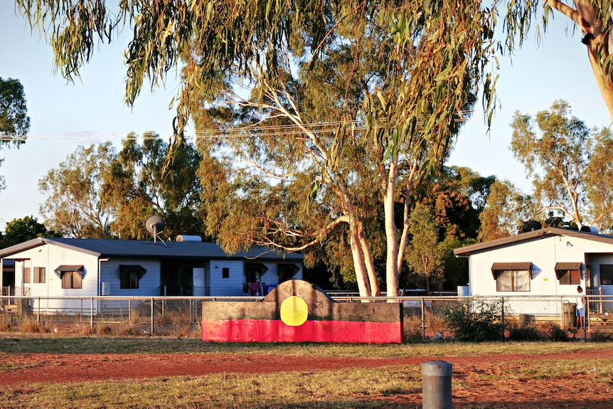 A plaque representing an Aboriginal flag in a community park