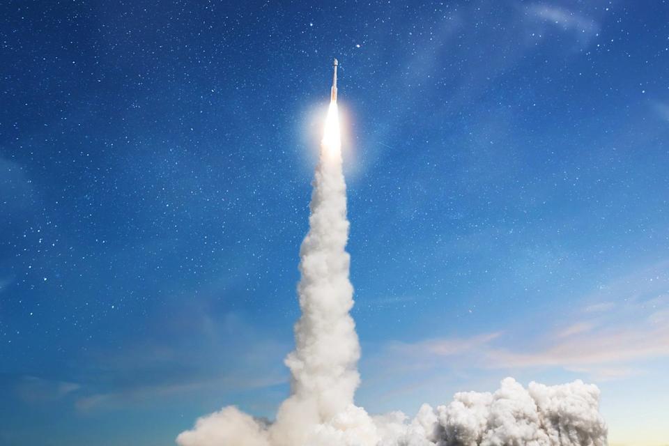 A rocket blasts off into the sky.
