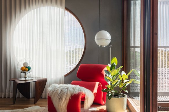 A large circular window makes a dramatic statement on the upper floor.