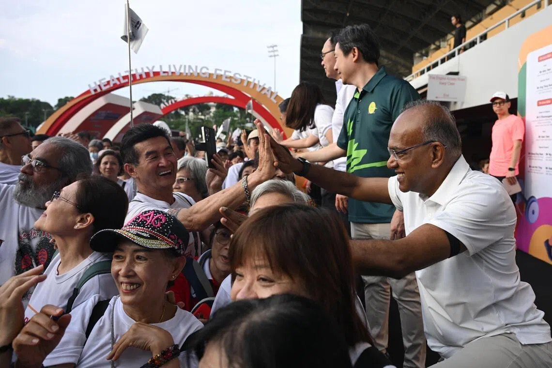 Home Affairs Minister K Shanmugam greeting participants during the brisk walk at the annual Healthy Living Festival @ North West on June 7.