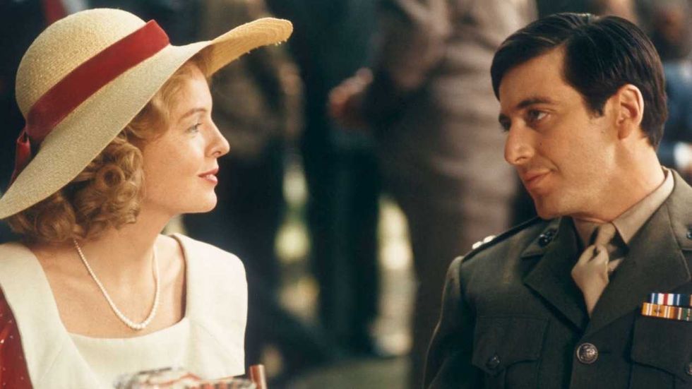 Diane Keaton and Al Pacino looking at one another across a table in The Godfather