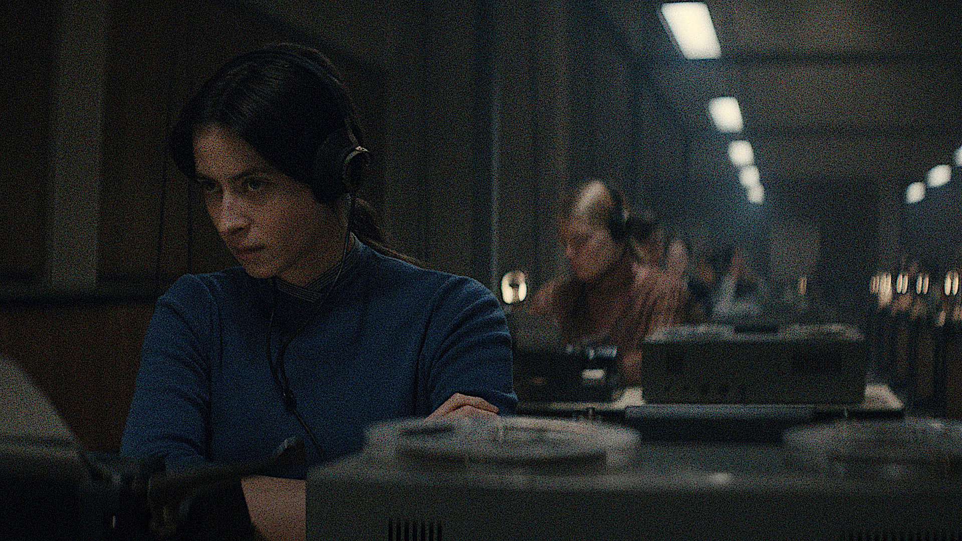 a Soviet woman at a listening station desk