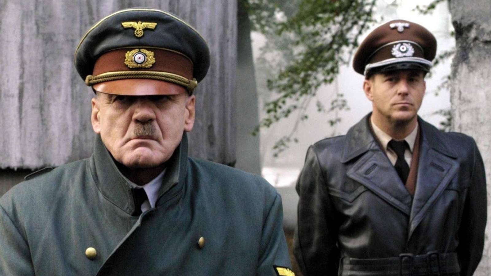 Bruno Ganz as Adolf Hitler with a soldier behind him in Downfall.