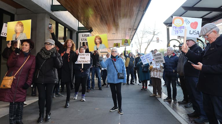 Dozens of residents waved signs and chanted in support of Lisa Austin ahead of Thursday's vote.