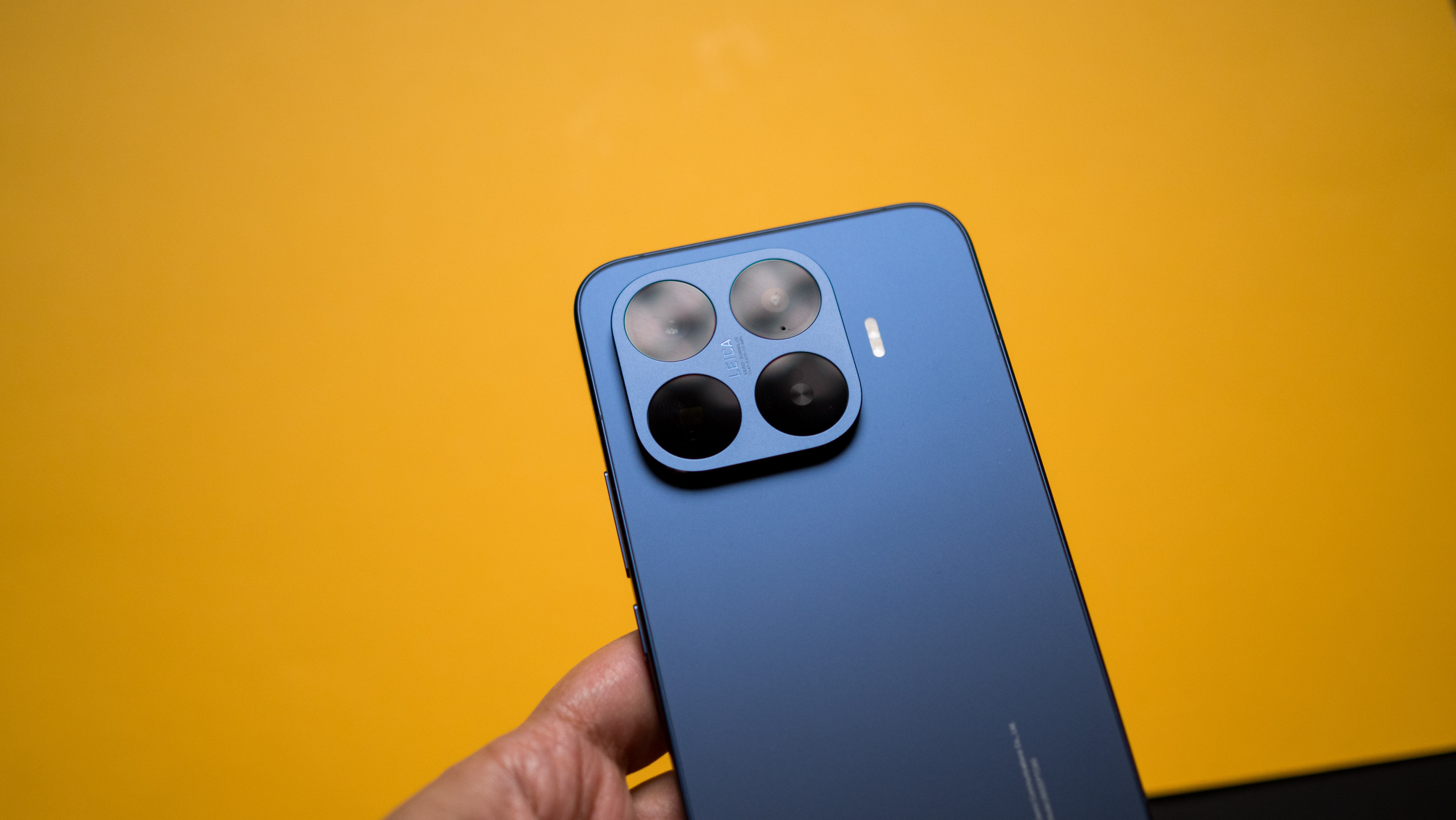 Xiaomi 17T Pro rear view against a colorful craft sheet highlighting the design