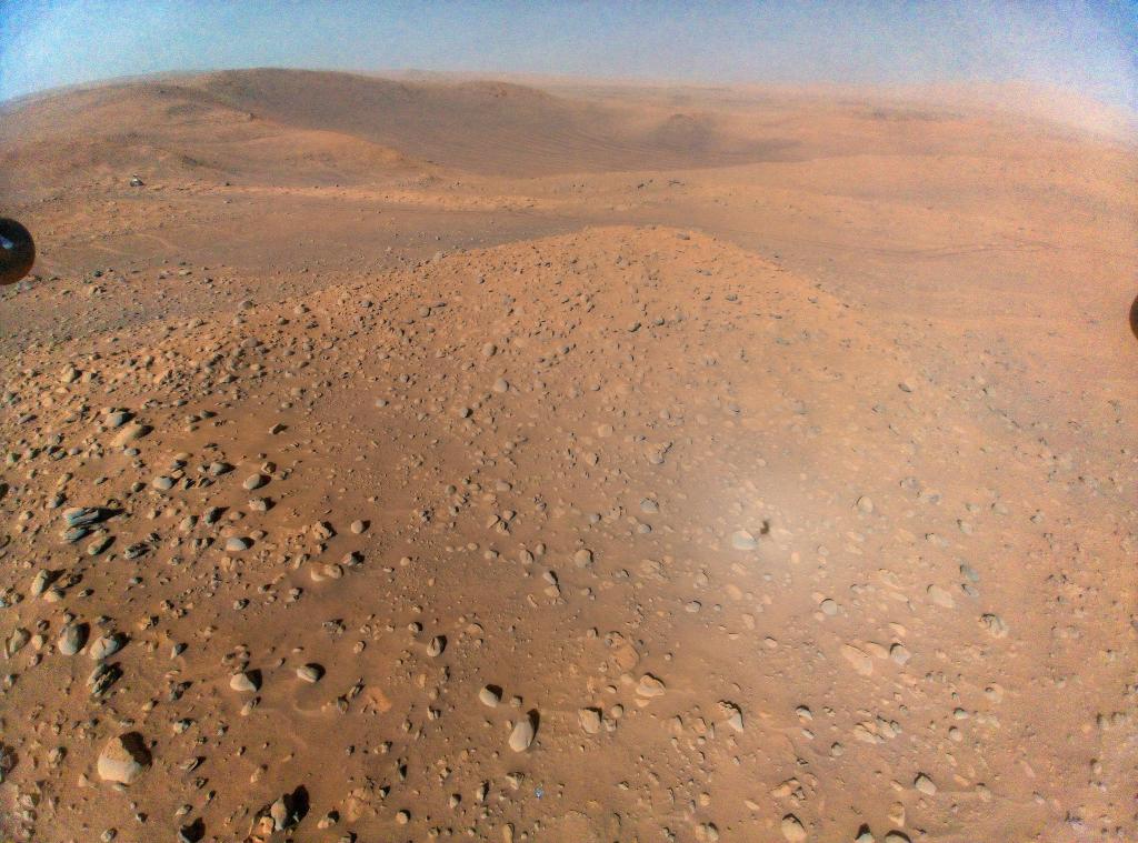 NASA’s Perseverance landed along with the Ingenuity helicopter, which proved flight in Mars’ thin atmosphere was possible. This view from Ingenuity — taken from an altitude of about 40 feet (12 meters) during its 51st flight — includes the rover, visible as a whitish speck at upper left.