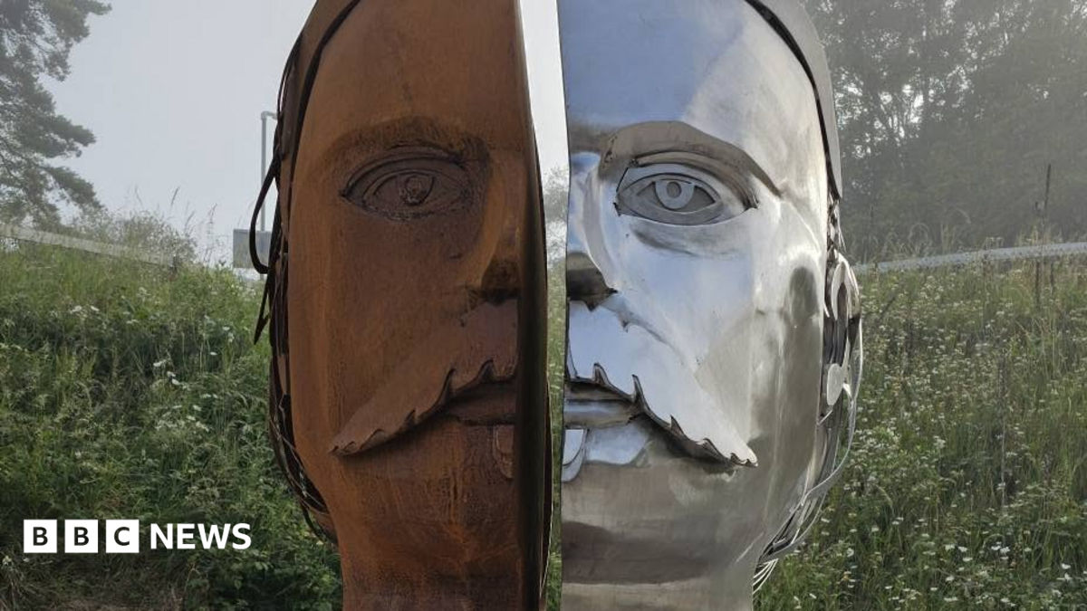 Sculpture showing a face in two halves, one side is shiny silver metal, the other is rust