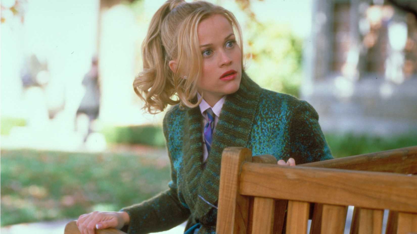 Elle Woods (Reese Witherspoon) looking shocked on a bench in Legally Blonde
