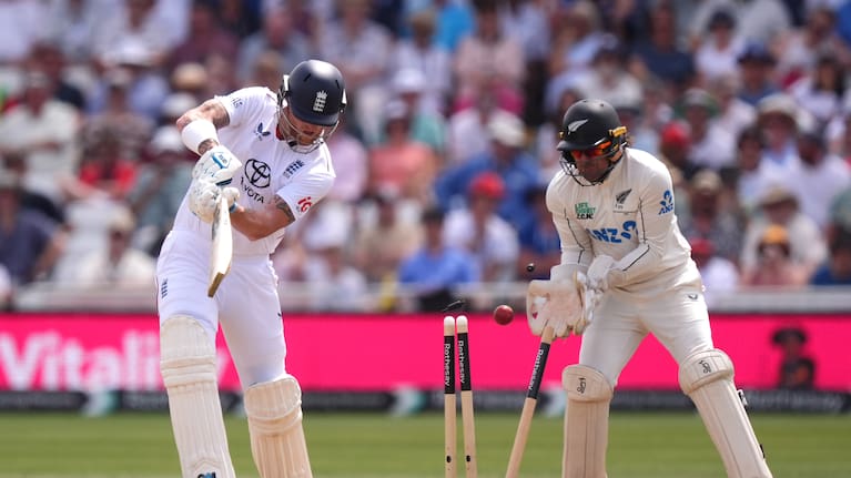 England's Ben Stokes, left, is bowled out by New Zealand's Zak Foulkes, during day three of the Third Test cricket match between England and New Zealand.