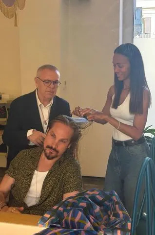 Zoe Saldaña brushes Marco Perego's hair as he sits in front of a mirror in a photo shared the day before Zoe's 48th birthday on June 18, 2026.Credit: Zoe Saldaña/Instagram