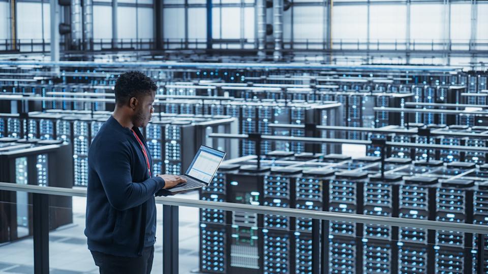 Tech overlooking a cloud data center.