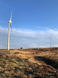wind turbines on scottish peatland, blue sky