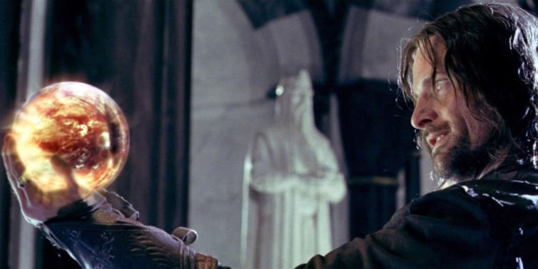 Film still from The Return of the King showing Aragon gazing at a seeing stone.