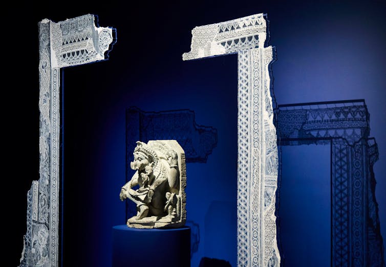 A statue framed by lace.