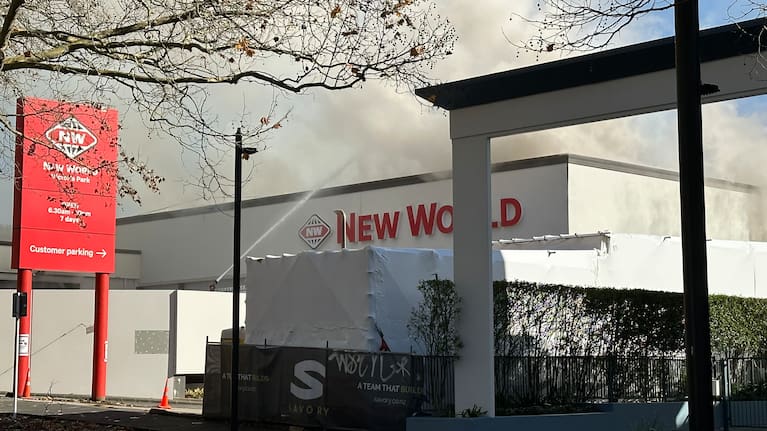 Firefighters spray water on the New World near Victoria Park.