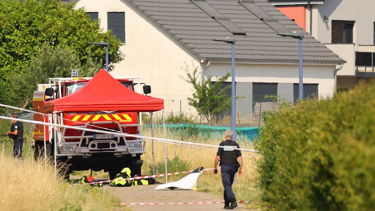 Forensic technicians examine a skydiving plane that crashed in Tomblaine northeastern France, killing all 11 people on board.
