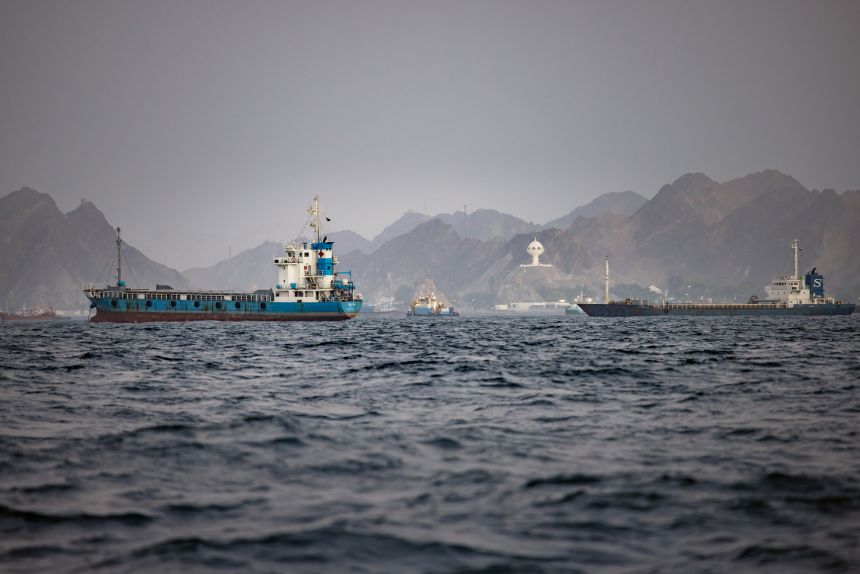 Oil tankers and cargo vessels remain anchored off Port Sultan Qaboos in Muscat, Oman, on June 21, 2026.