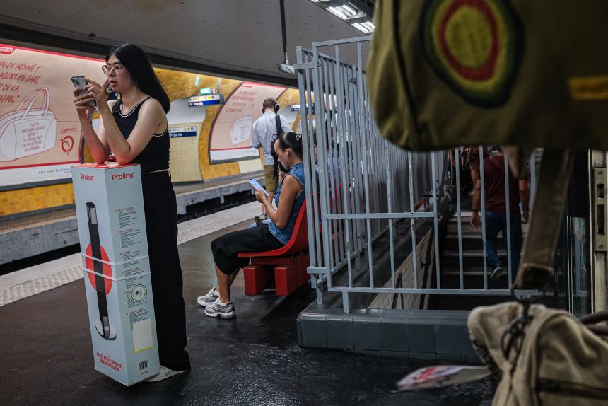 Commuters wait on a Paris Metro platform during hot weather on June 24, 2026 in Paris, France.