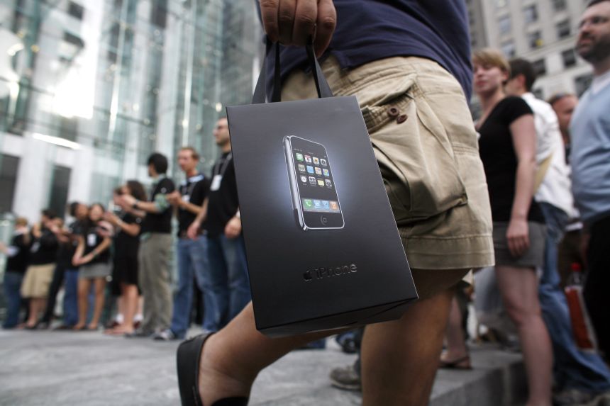 New iPhone owners exit Apple's flagship store on Fifth Avenue, in New York, on June 29, 2007.
